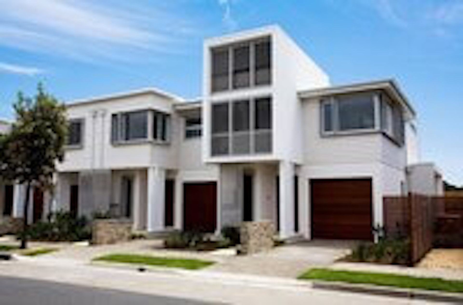 Modern home with white exterior and brown doors| Featured image for External Feature Wall Ideas | Creating Beautiful Exterior Feature Walls blog.