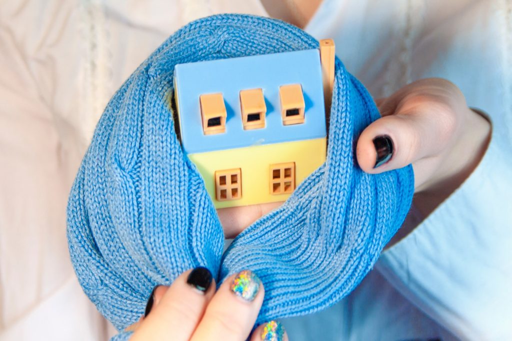 A home wrapped in a scarf | Featured image for the Benefits of Insulating Your Home blog from BetaBoard.