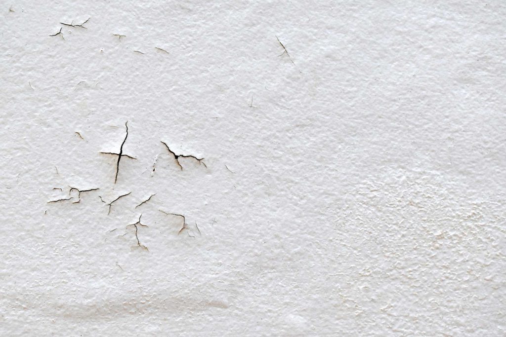 Damp white wall | Featured image for the How to Prevent Wall Dampness blog from BetaBoard.