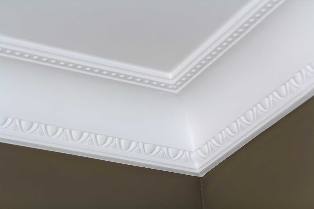 Close up photo of white ceiling cornice | Featured image for the Cornice Decorating Ideas blog from BetaBoard.