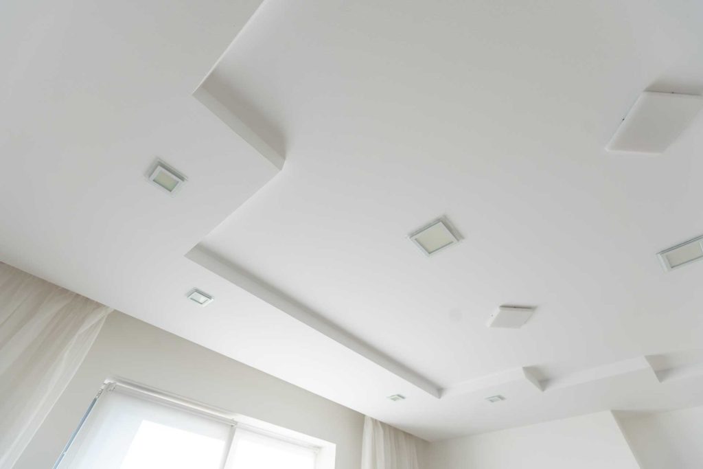 White plastered ceiling with recessed lights | Featured image for the How to Plaster a ceiling blog from BetaBoard.