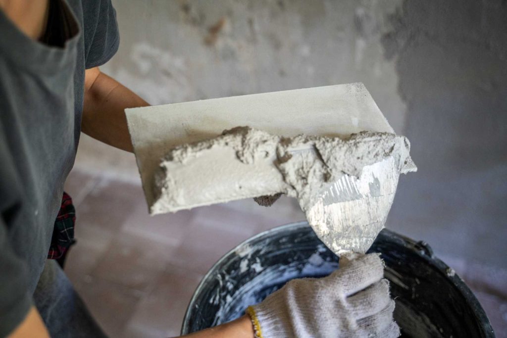 Plasterer working | Featured image for the Plastering Tool Kit blog from BetaBoard.