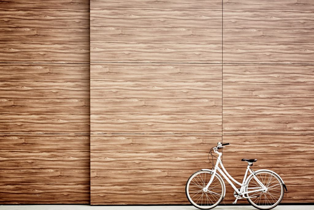 White Bicycle Leant Against a Textured Wall | Featured image for the Sophisticated Textured Wall Ideas blog by BetaBoard.